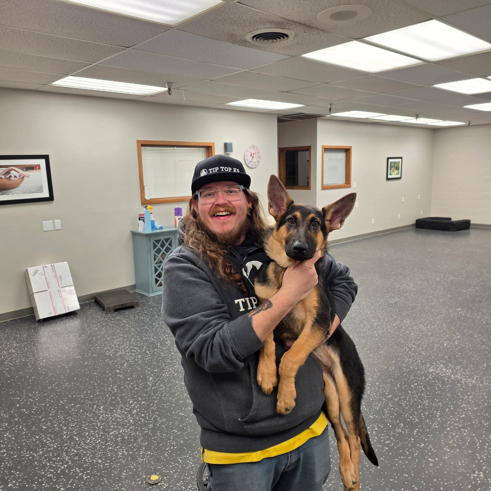 Joseph with a German Shepherd puppy at the start of its training in Kansas City